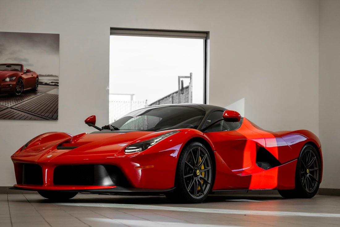 red ferrari 458 italia parked in front of white wall